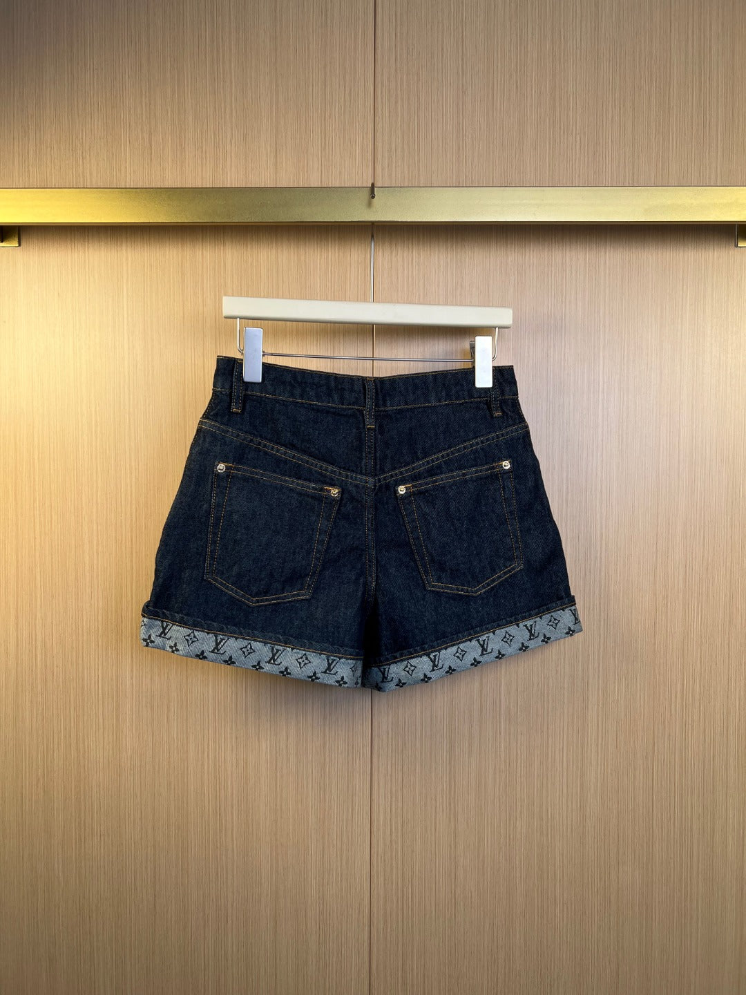 Louis Vuitton denim shorts on hanger with monogram-trim hem and front pockets