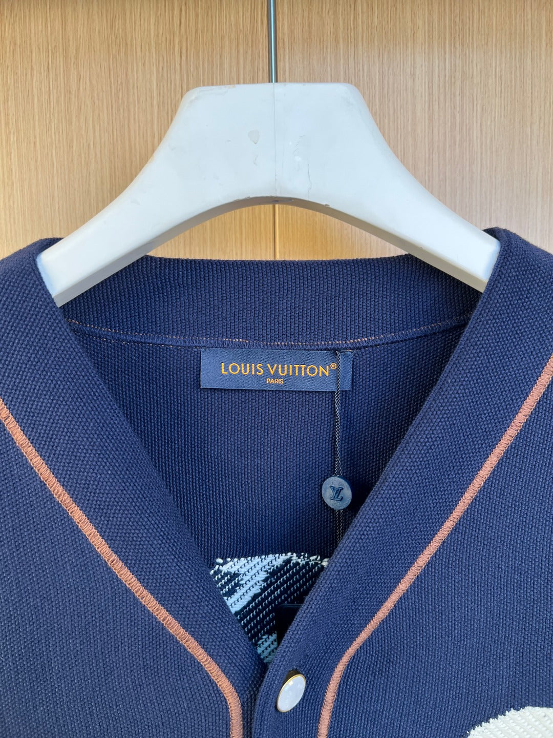 Navy knit polo shirt neckline with Louis Vuitton logo label