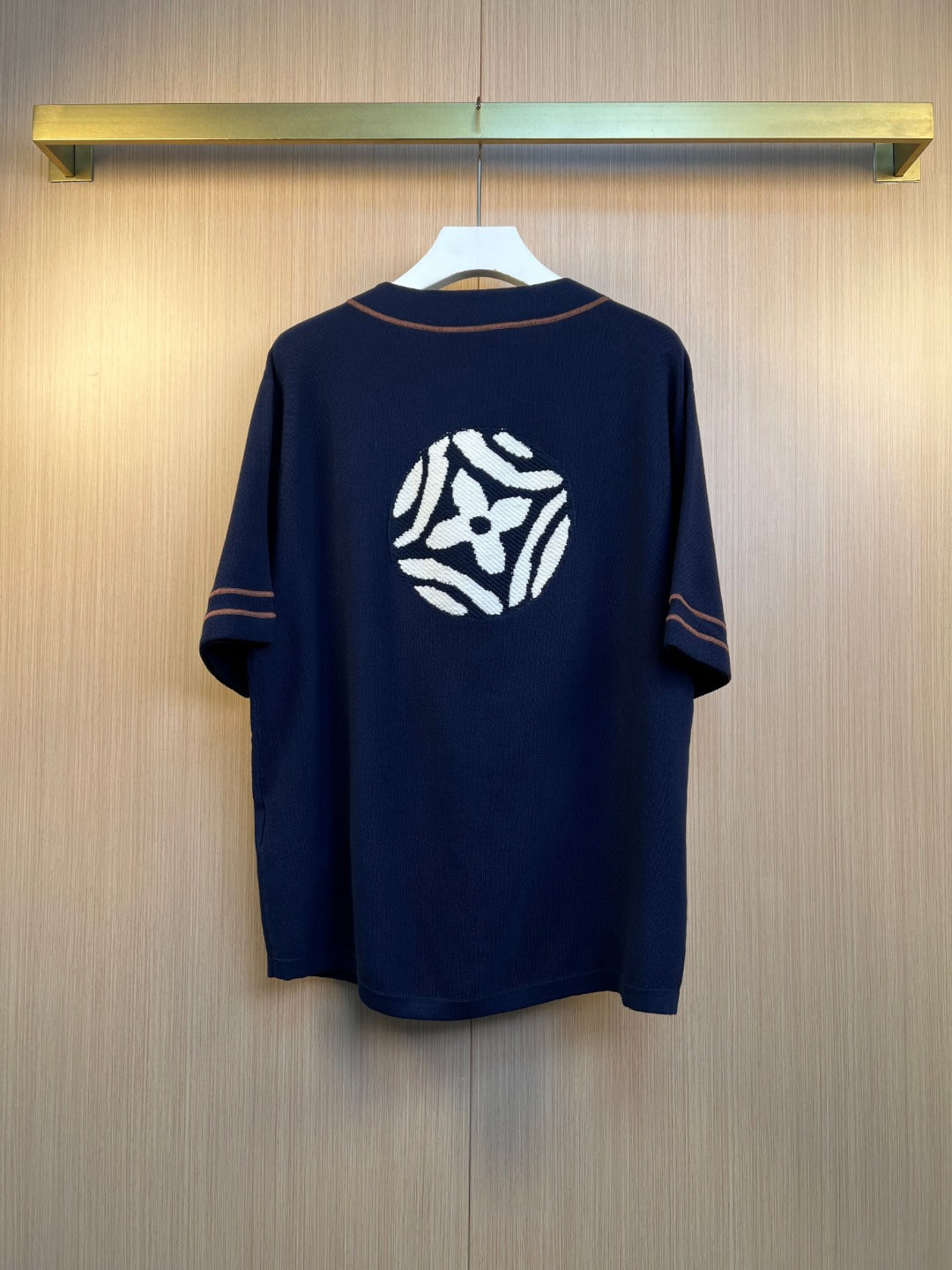 Navy knit polo shirt with large back crest graphic