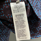 Clothing care label inside long-sleeve Gucci shirt, white tag text