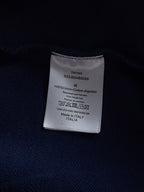 Dior long garment care label on dark fabric, 100% cotton