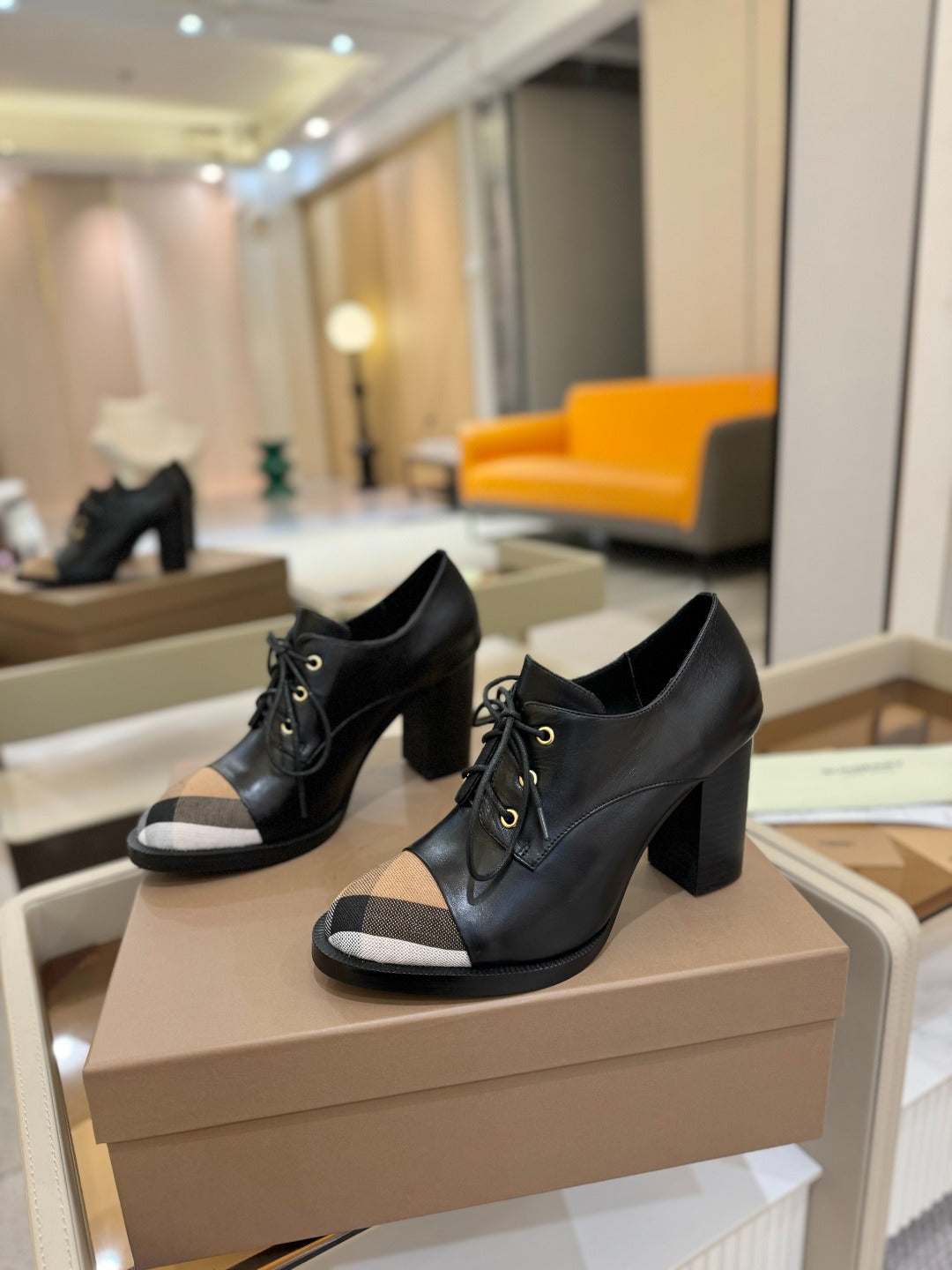 Black lace-up high-heel shoes with beige check toe panel on shoebox