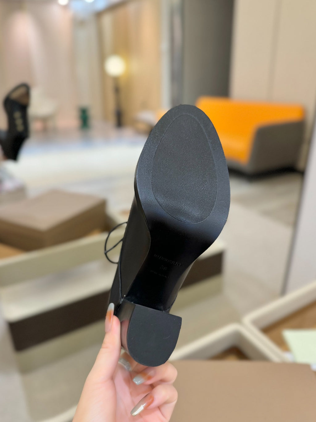 Black high-heel shoe with flat sole and block heel