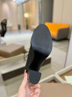 Black high-heel shoe with flat sole and block heel
