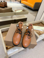 Burberry lace-up leather shoes, tan with beige heel tab and black rubber sole.