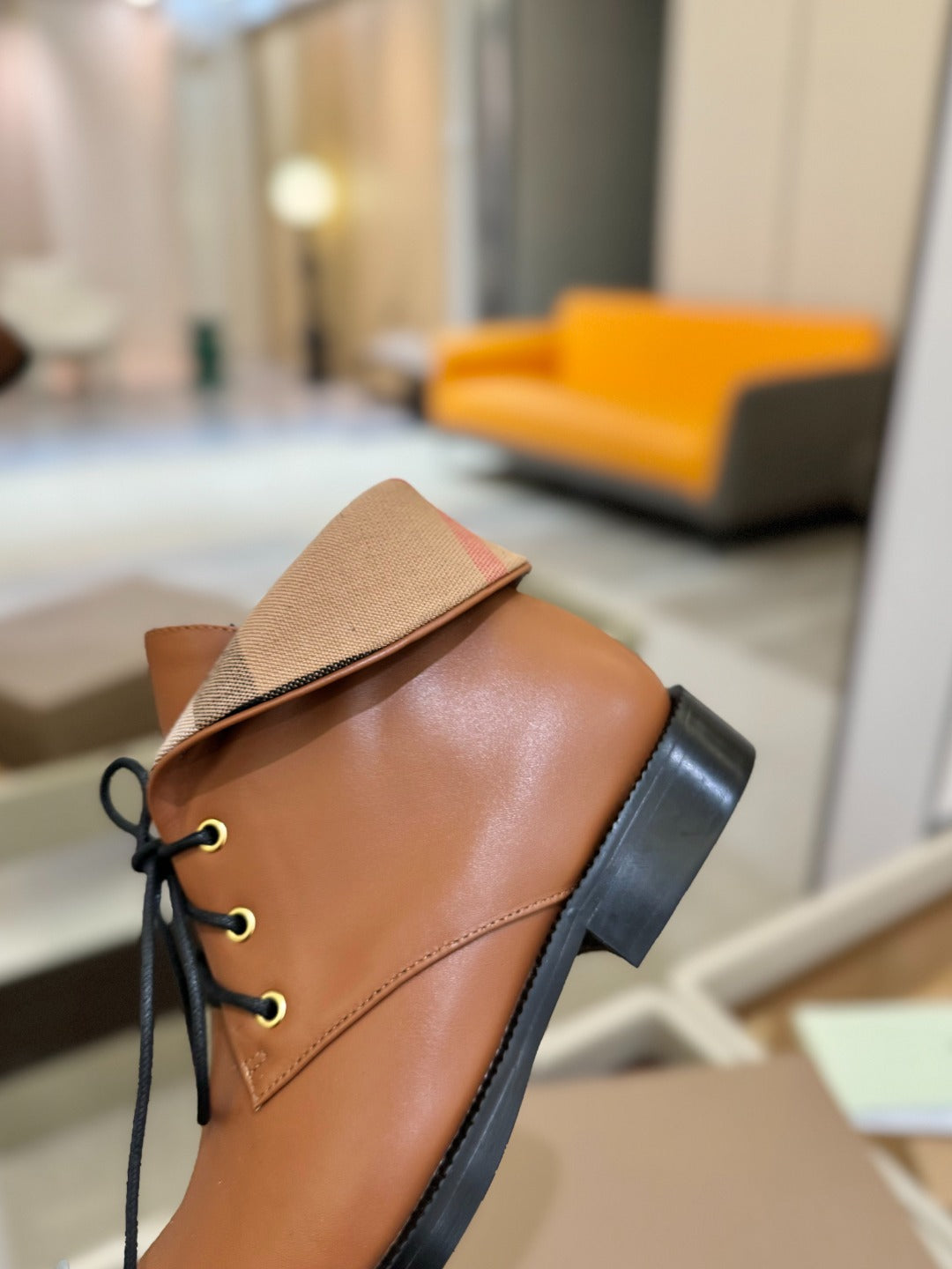 Burberry lace-up leather shoe, tan side with beige collar tab and black heel.