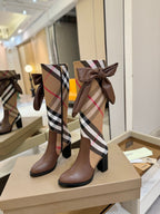 Brown heeled boots with Burberry check shaft and front bow