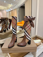 Brown heeled boots with Burberry check shaft and bow detail, side view