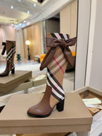Brown heeled boots with Burberry check shaft and bow at the top