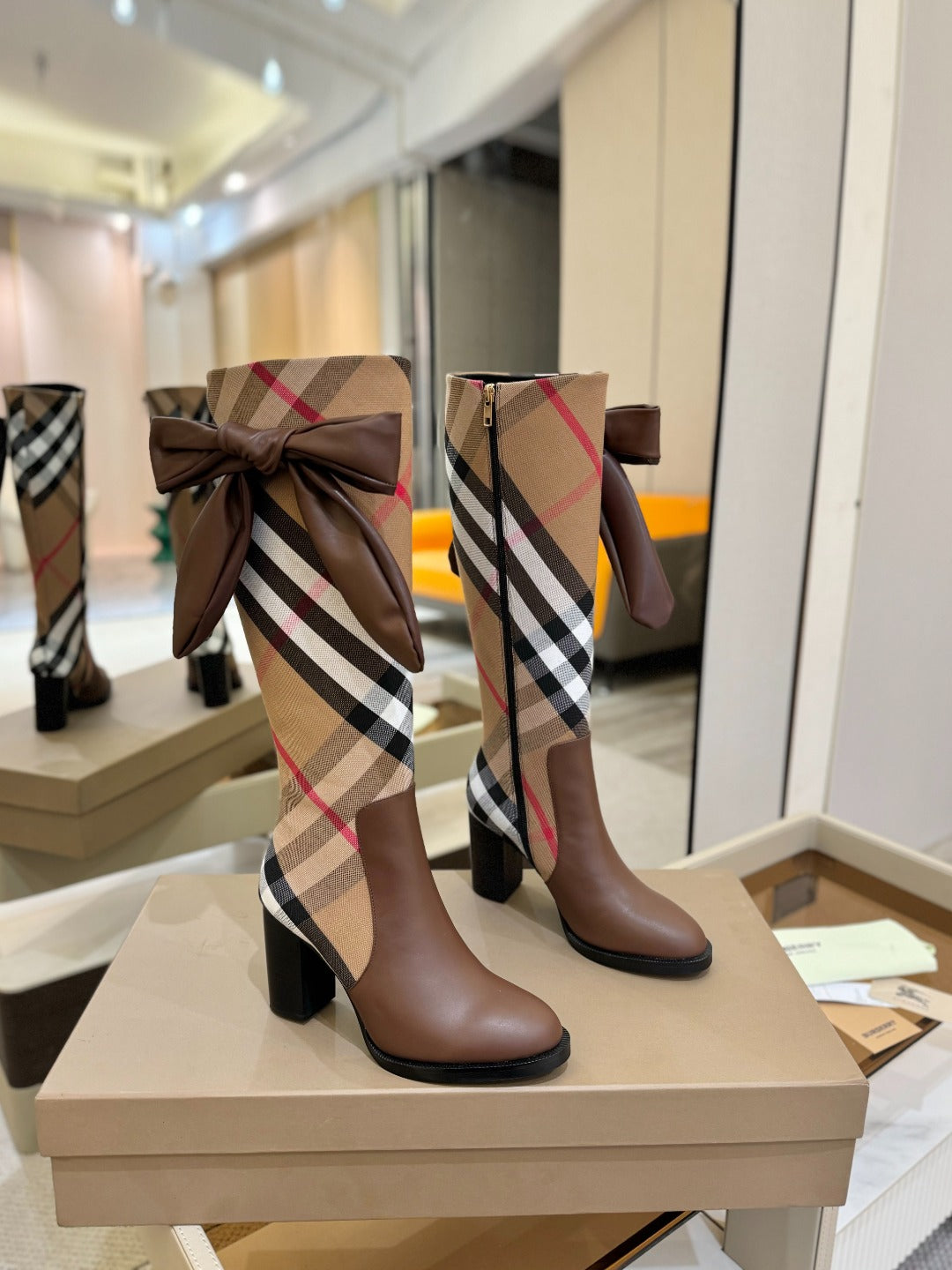 Pair of brown heeled boots with Burberry check panels and bow details