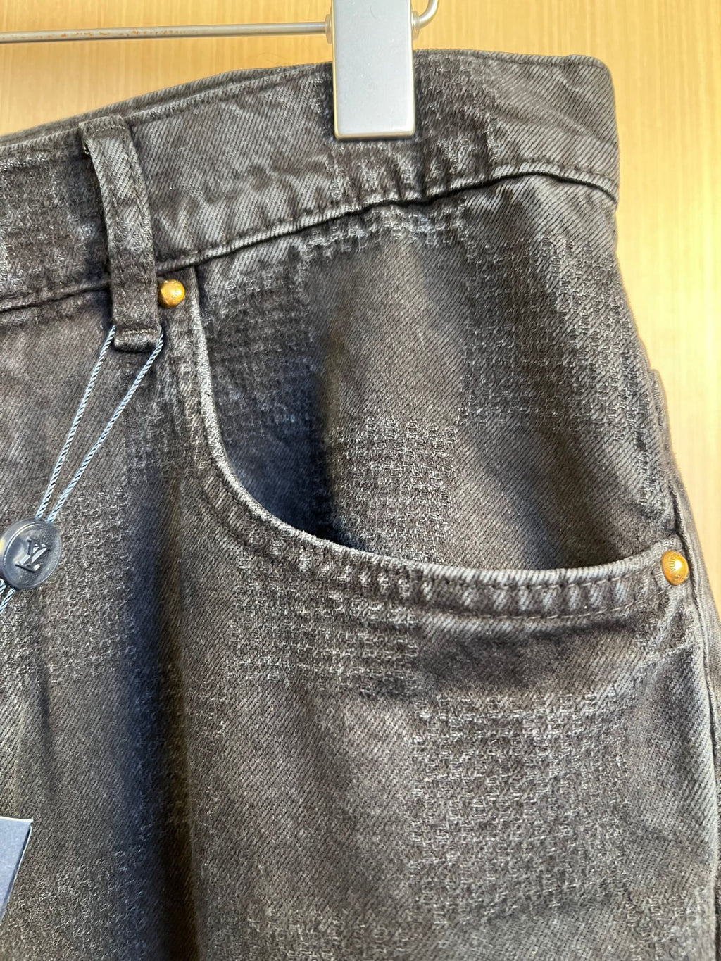Dark denim jeans close-up of curved waistband and front coin pocket