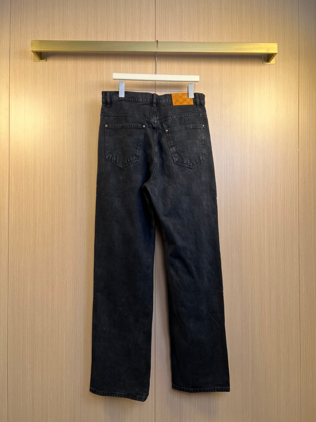 Dark denim jeans on hanger with relaxed straight-leg fit