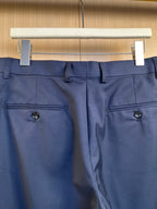 Navy pants front with two side pockets and button closure.