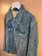 Denim jacket with flap chest pocket, pointed collar, and round metal buttons.