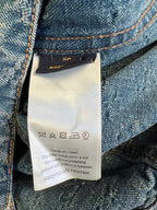 Garment care label tag with cleaning instructions and washing symbols.