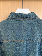 Denim jacket back yoke with pointed collar and stitched flap pocket details.