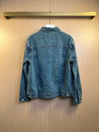 Denim jacket back view with button closure and two lower flap pockets.