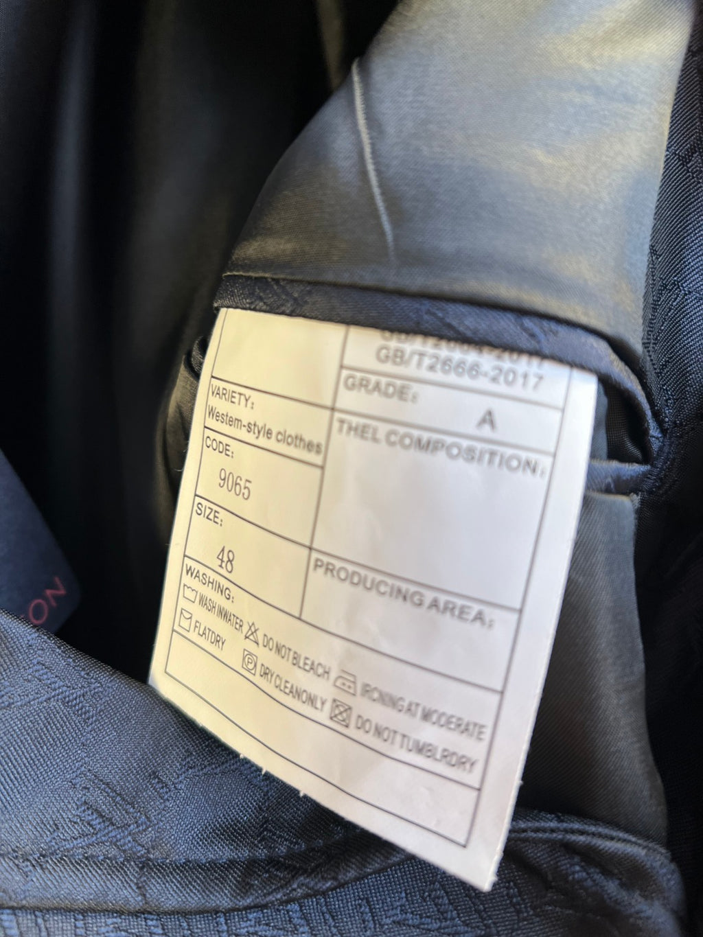 Blazer inside label card with size, grade, and production information