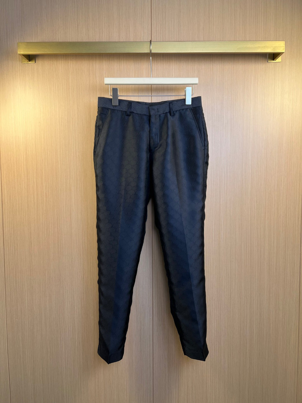 Louis Vuitton navy trousers with allover monogram pattern, button front, belt loops.