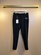 Black Dior trousers with belt loops, front zip fly, and brand tag on hanger