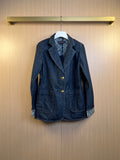 Dark blue denim jacket with notched lapels, front buttons, and two chest pockets