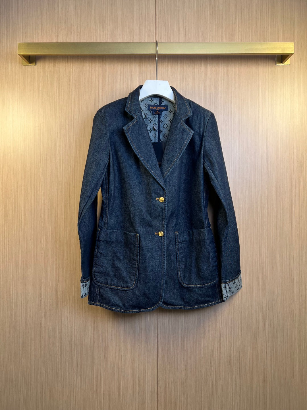 Dark blue denim jacket with notched lapels, front buttons, and two chest pockets