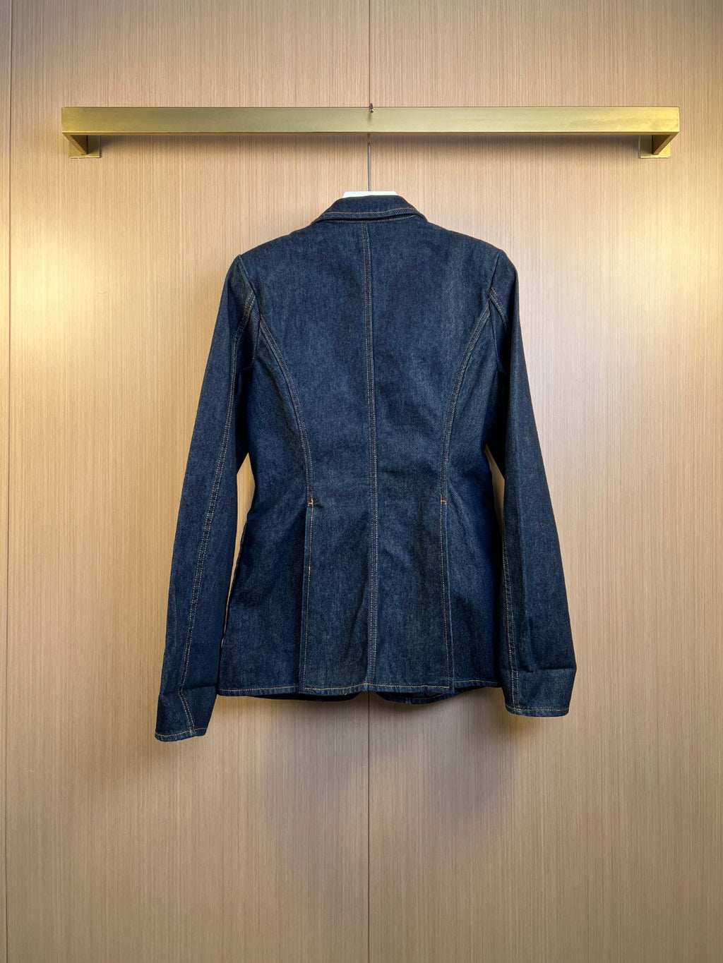 Dark blue denim jacket back view with center seam and cuffed sleeves