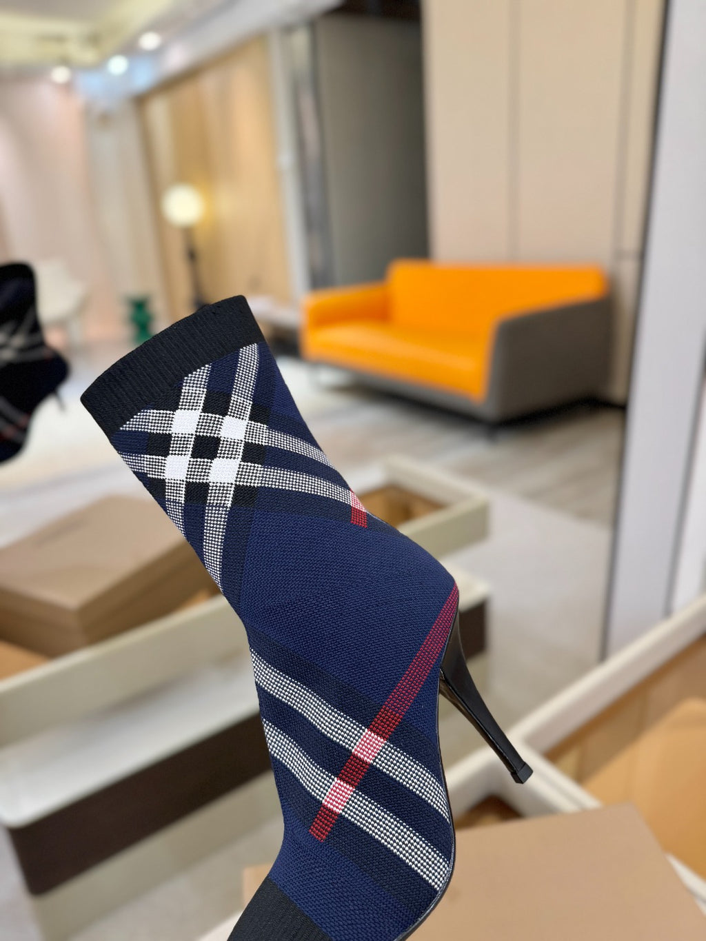 Navy ankle boot with large white check and red plaid stripe, side view