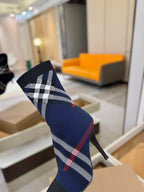 Navy ankle boot with large white check and red plaid stripe, side view