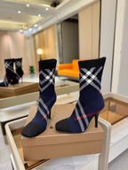 Navy ankle boots with plaid cuff and stiletto heel, front side view