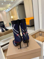 Navy ankle boots with side plaid stripe and stiletto heel, rear view