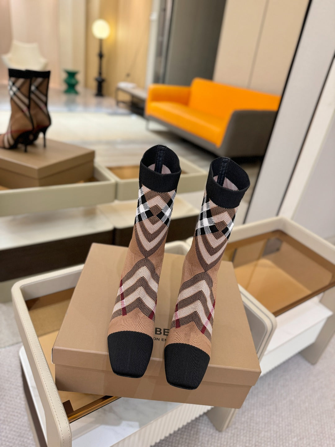 Burberry check knit heeled ankle boots on display, close rear view