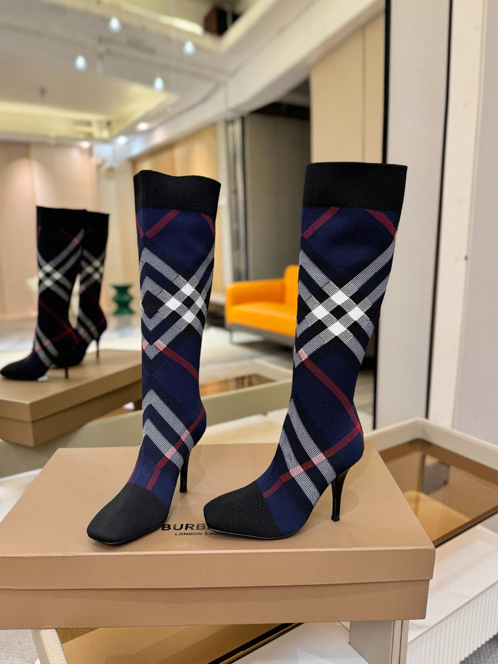 Knee-high knit boots with navy knit shaft, red and white check pattern, stiletto heel