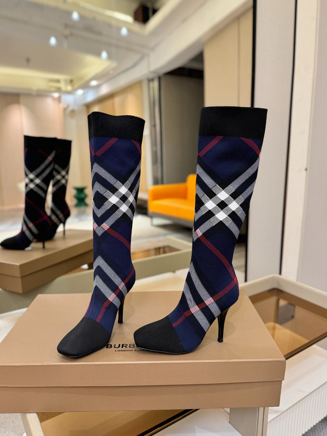 Knee-high knit boots with navy knit shaft, red and white check pattern, stiletto heel