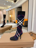 Knee-high knit boots with navy, red, and white check pattern and stiletto heel