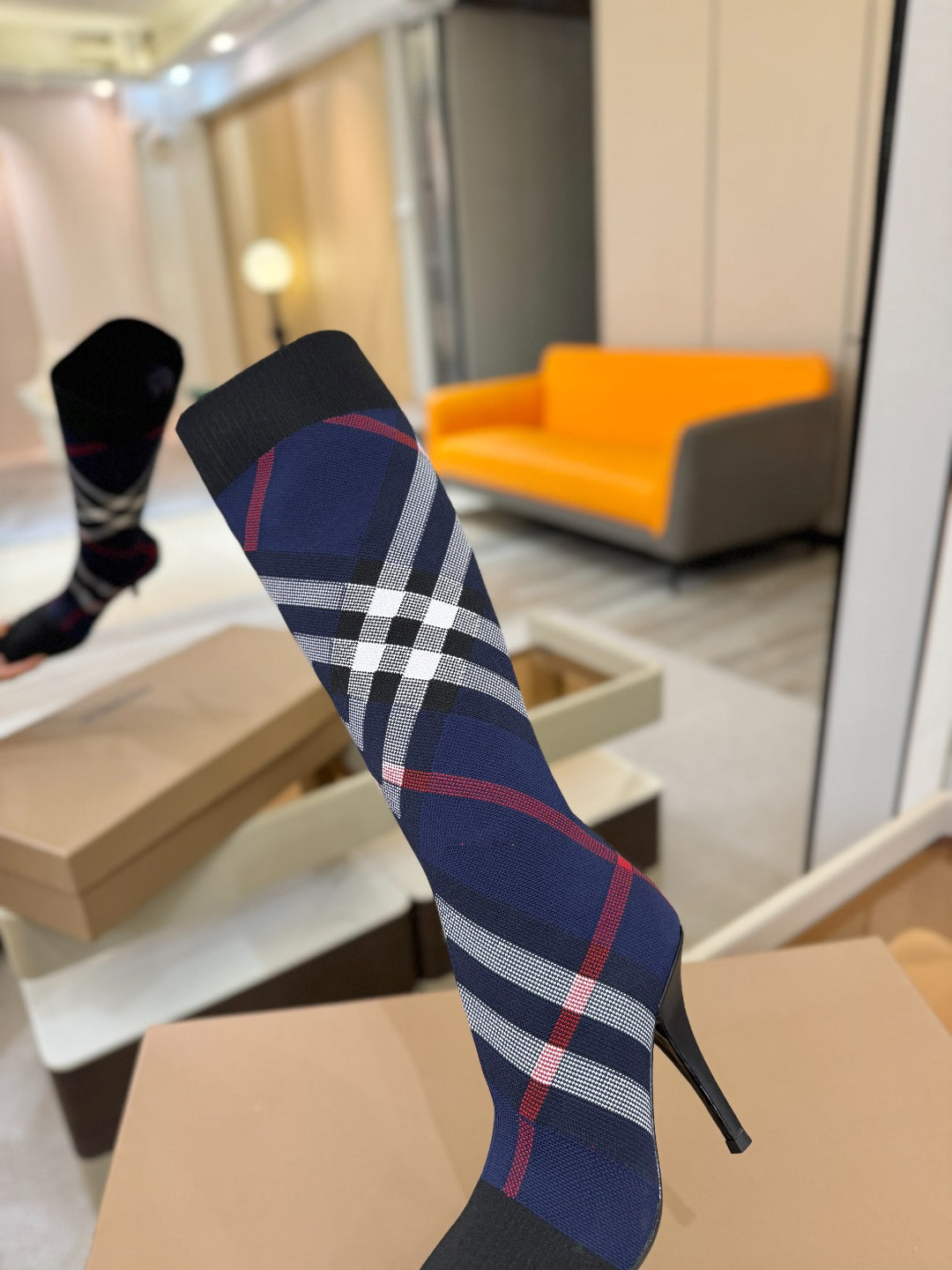 Knee-high knit boots with navy knit shaft, red and white check pattern, stiletto heel
