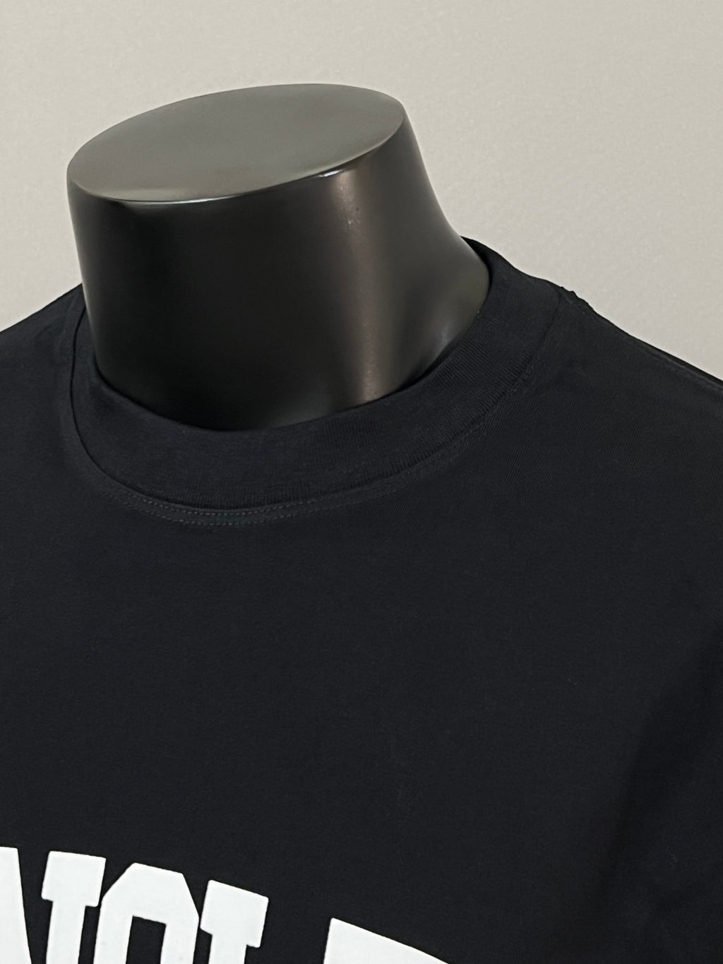 Black Moncler long-sleeve T-shirt neckline close-up with white MONCLER text