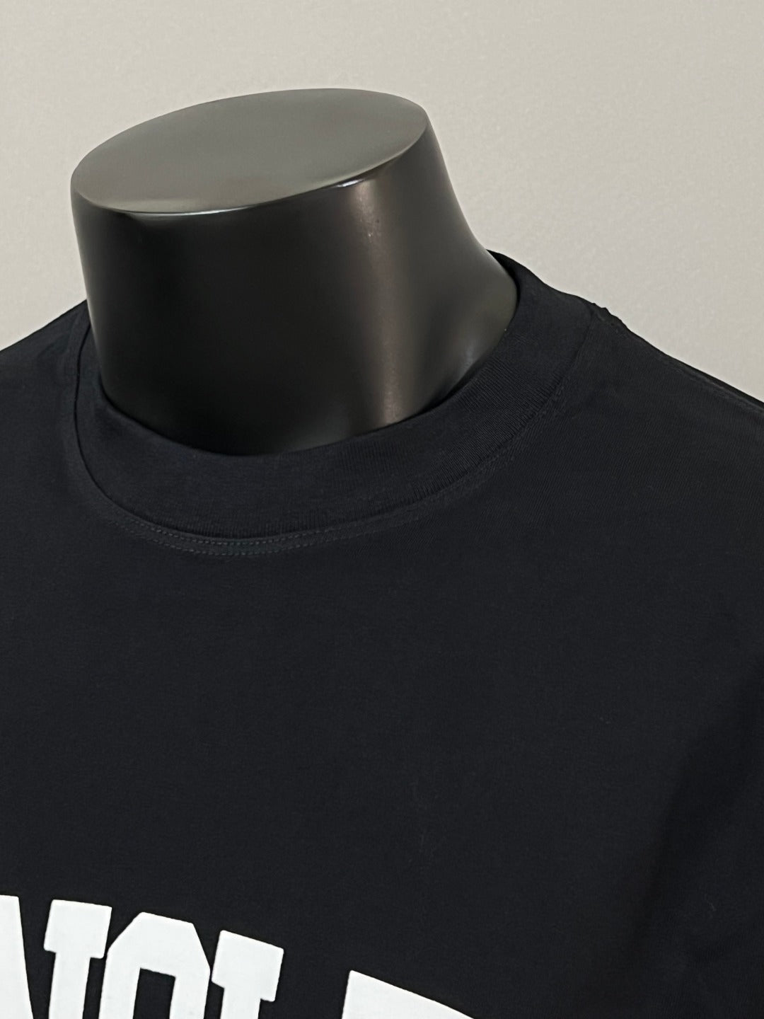 Black Moncler long-sleeve T-shirt neckline close-up with white MONCLER text