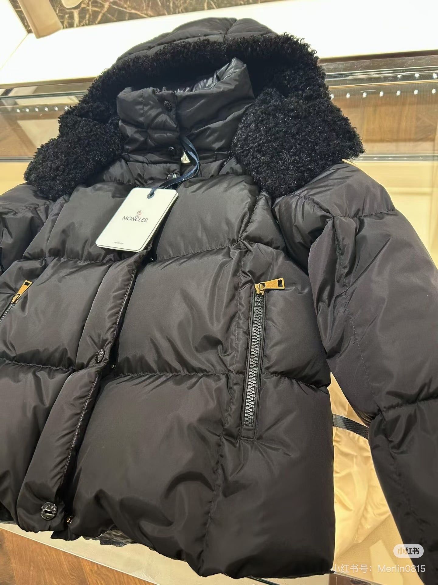 Long puffer jacket with faux-fur hood, dark charcoal color, front zipper