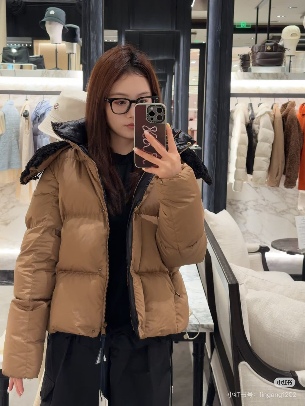 Tan long puffer jacket with faux-fur hood and front zipper, front view