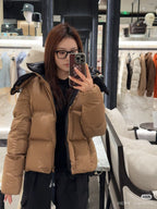 Tan long puffer jacket with faux-fur hood and front zipper, front view
