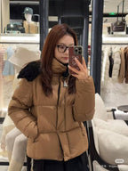 Tan long puffer jacket with faux-fur hood and front zipper, wrist-length sleeves