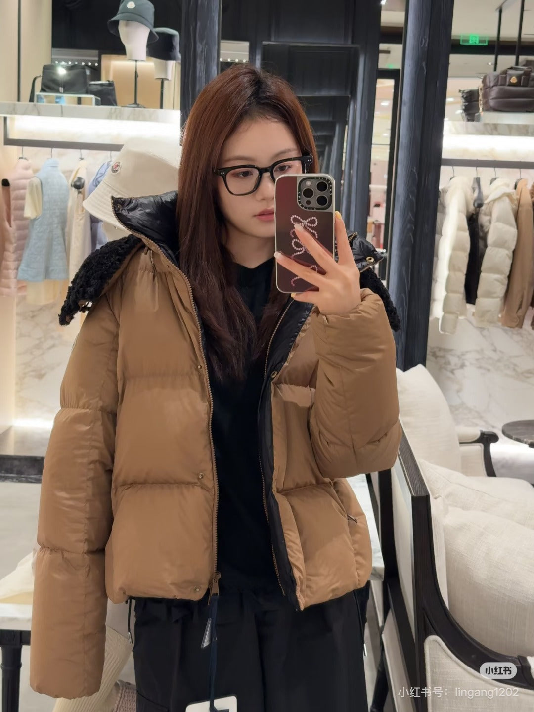 Tan long puffer jacket with faux-fur hood and front zipper, side profile view