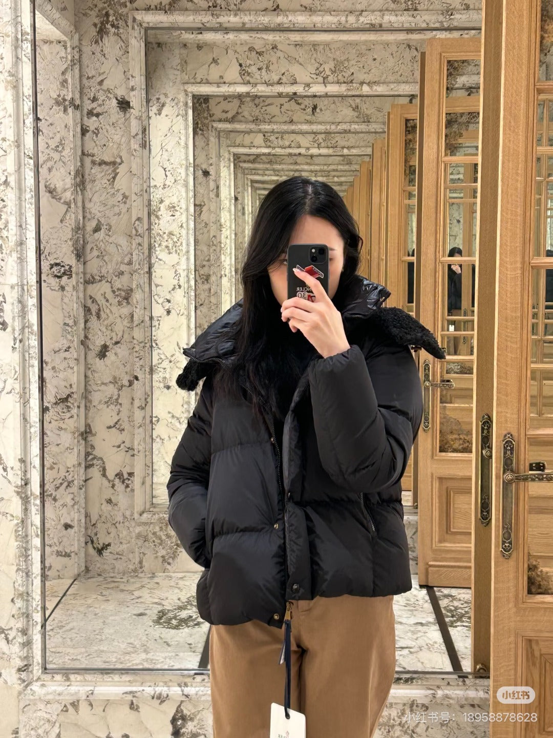 Black long puffer jacket with faux-fur hood, front zipper, relaxed fit