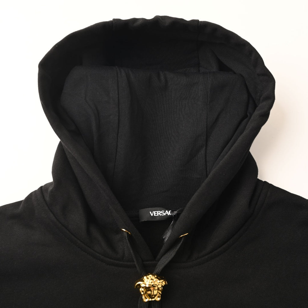 Versace black hoodie neckline with gold crest and zipper pull
