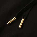 Black hoodie drawstrings with gold aglet tips