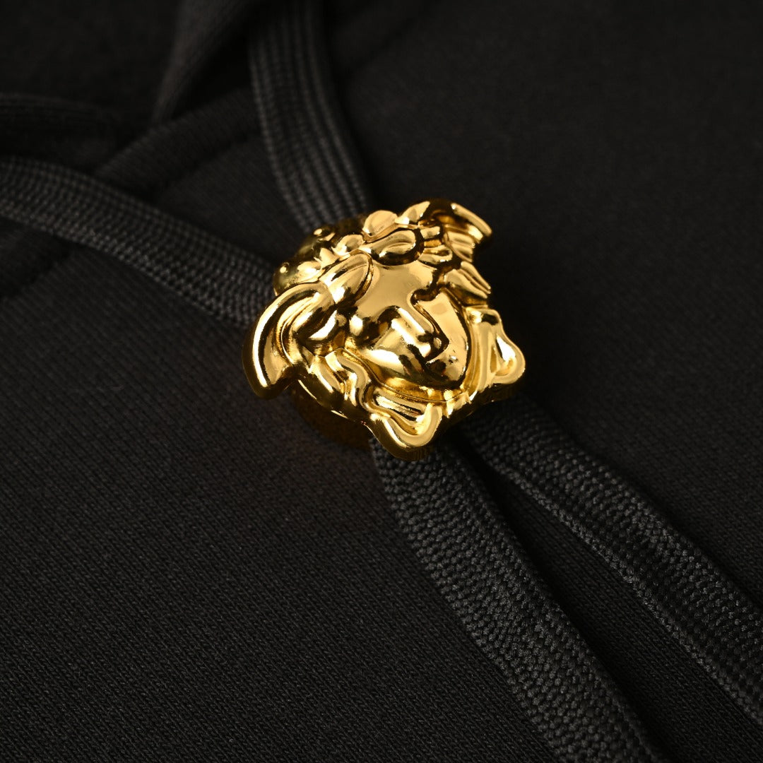 Versace gold lion crest on black hoodie drawstring ends