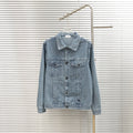 Burberry long denim jacket with button front, pointed collar, and chest flap pockets