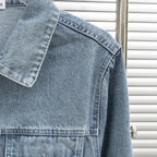 Denim jacket back yoke and shoulder close-up with stitched panel seams
