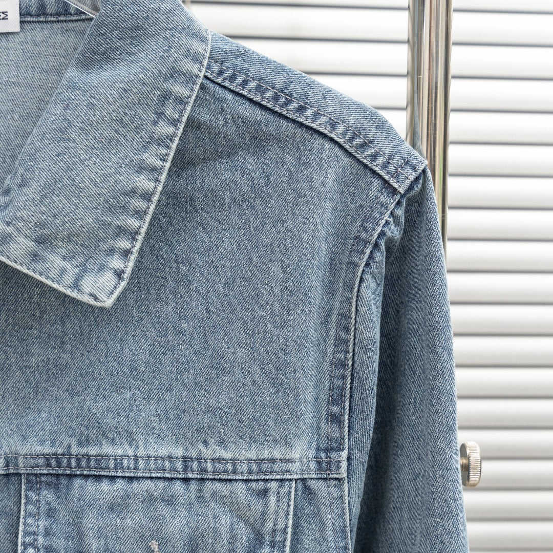 Denim jacket back yoke and shoulder close-up with stitched panel seams